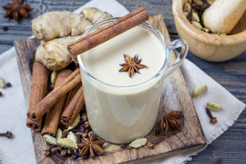 Masala chai with spices. Cinnamon stick, cardamom, ginger, clove, star anise, black pepper.