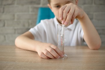 Little boy conducting experiment on water
