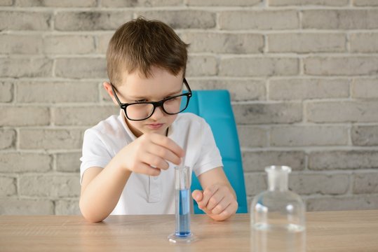Little boy make an indoor chemical test with water