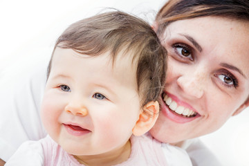 close-up of a smiling young woman with her baby on white background