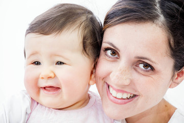 close-up of a smiling young woman with her baby on white background