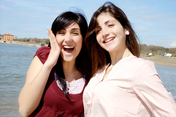 Cute girls smiling happy in front of sea