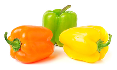 colored peppers over white background