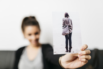 Young pretty woman holding a picture