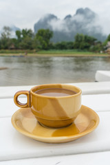 Coffee cup ceramic with Song river (Vang Vieng Laos) and cloud b