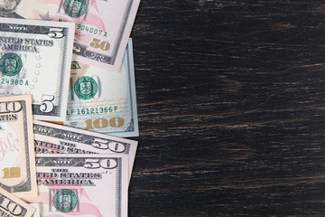 USA dollars notes on a dark wooden background