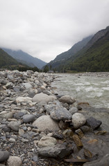 Snow Melt makes the River Bed Wide. Snow melt feeds this river from the mountains in the Pyrenees. In the height of summer, the river bed is exposed as most of the winter snow has melted.