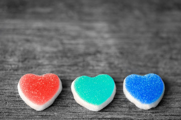 Obraz premium Colorful candy sweet hearts on wooden background.- Vintage filte