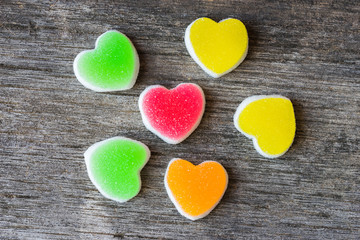Obraz premium Colorful candy sweet hearts on wooden background.- Vintage filte