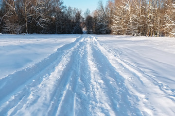 Obraz premium Winter landscape with road and a forest