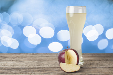  apple juice on the wooden table,bokeh background