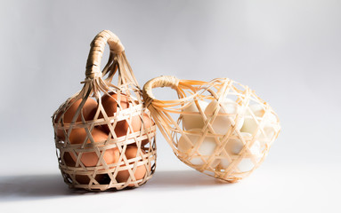 egg in basket wicker on white background,Duck eggs in baskets .
