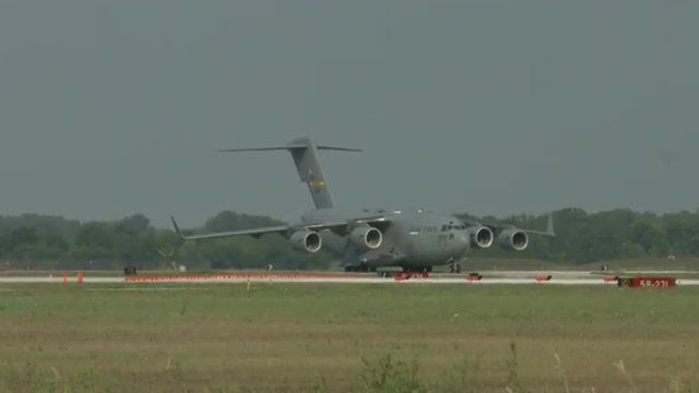 Boeing C-17 Globemaster military transport plane taxiing at airfield on hot summer day with heat haze visible. Used by the United States Air Force and developed by McDonnell Douglas.