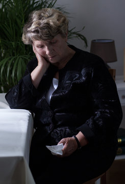 Lonely widow crying after funeral