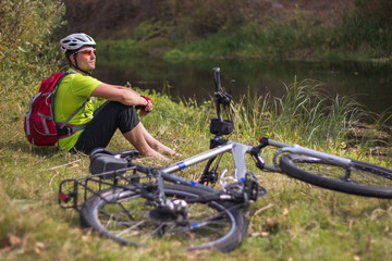 Men riding a bike helmet and a backpack.