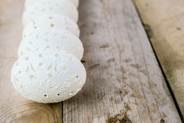 Beautiful unique Easter eggs on wooden background