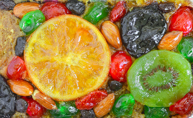 Colourful fruit and nut topping on a cake top view texture
