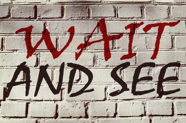Wall with graffiti that says "Wait end see" (abstract background