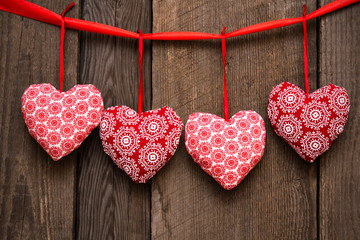 Valentines day background with handmade toy hearts on wooden bac