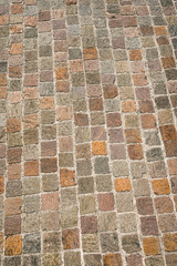 Fototapeta premium Porphyry Stone Floor - Sanpietrini or sampietrini / Multi colored blocks of porphyry (sanpietrini), typical urban paving in Italy