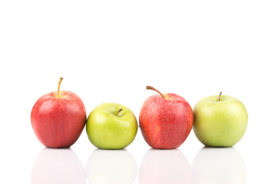 Two green and red apples standing in a row on white background.