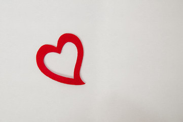 red felt heart on rough textured painters canvas background