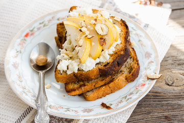 toast for breakfast with cream cheese and sweet pear, nuts