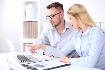 Obraz premium Two successful business partners working at meeting in office