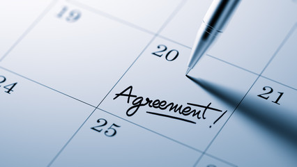 Closeup of a personal agenda setting an important date written w