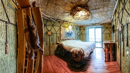 Unique ethnic interior. Traditional, national, design. The hotel room. Ukrainian style and specific decorations of Scythia historical period. Europe, Ukraine, Carpathians, Hotel History.