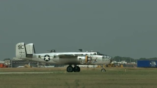 B-25 Mitchell from World War II waits on taxiway at airfield.  Recorded in 4K, ultra high definition.