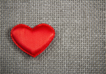 Red textile heart  on grey wicker background. Valentines Day card
