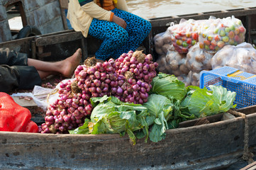 Vegetables sold from boat in Mekong delta Cai Rang floating market in Can Tho Vietnam