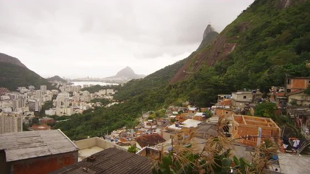 Slow panning shot over a favela and lagoon in Rio de Janeiro, Brazil