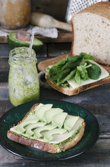 Healthy sandwich with cheese, pesto, avocado and spinach