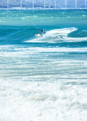 Vertical composition view of kite-surfer having fun in ocean water at summer