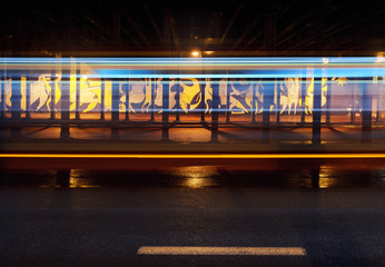 Vehicular light trails and graffiti under the bridge in Katowice