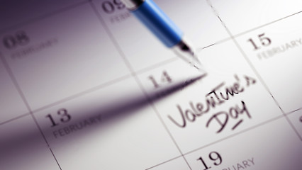 Closeup of a personal agenda setting an important date written w