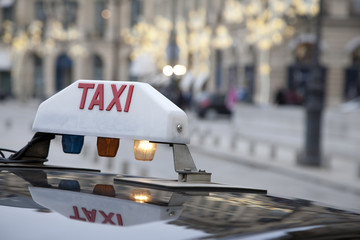 Parisian Taxi with Christmas Decoration in Background - obrazy, fototapety, plakaty