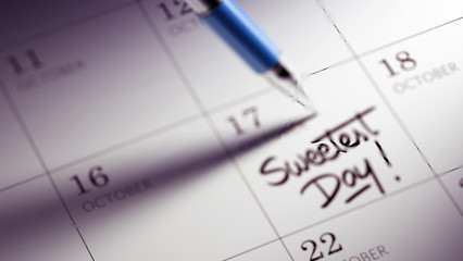 Closeup of a personal agenda setting an important date written w