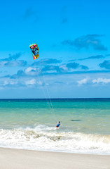 Active lifestyle sport background. Kite surfer near ocean coast beach