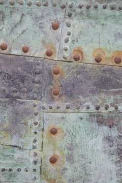 Close up of Green Metal Background with Rusty Nails