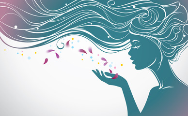 Beautiful girl with long hair blows away flower petals from her palm