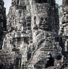 Fototapeta premium Faces and figures in Angkor Wat Cambodia. Bayon temple in Angkor Thom