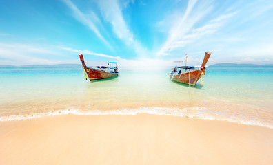 Fototapeta na wymiar Thailand nature landscape. Sandy beach and travel boats on coast of tropical island near Phuket