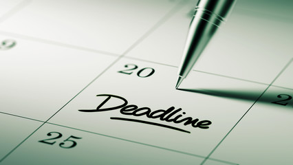 Closeup of a personal agenda setting an important date written w