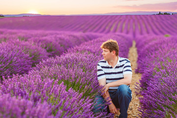 Young man in lavender fields, in Provence, France