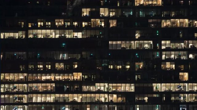 Time lapse of employees populating offices till late in the evening