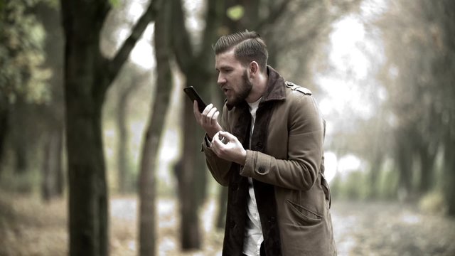 The angry man in expressive way swears by phone edited shots