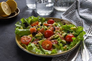 Salad with avocado, cherry tomatoes and pine nuts